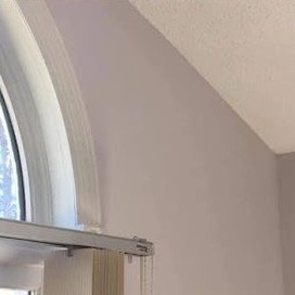 Interior corner they published: light walls, popcorn ceiling, arched window trim