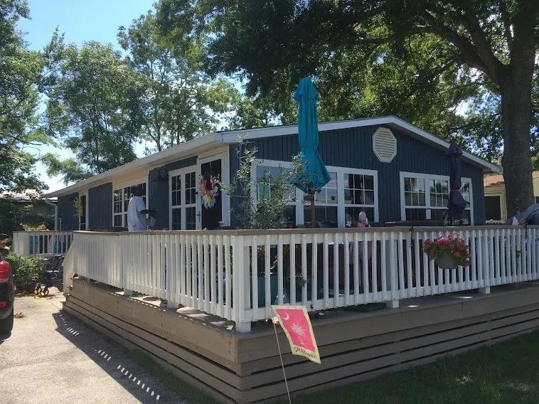 The 770 W Rowan St building they posted on their studio page — dark blue siding, white trim, deck